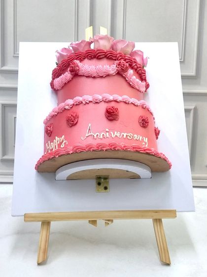 A fun and unique take on an anniversary cake, designed to look like a painting on an easel. This sculpted piece shows that any idea, no matter how unconventional, can be turned into a delicious work of art.