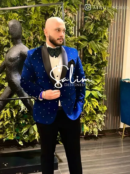 A client in a royal blue velvet tuxedo jacket dotted with crystals. Paired with a patterned bow tie, this look is fun, festive, and full of personality.