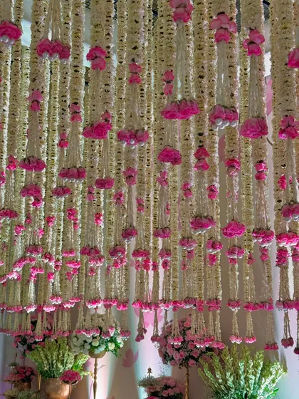 More views of the magical entrance, highlighting the density of the floral ceiling, the elegant decor pieces, and the soft, inviting lighting.