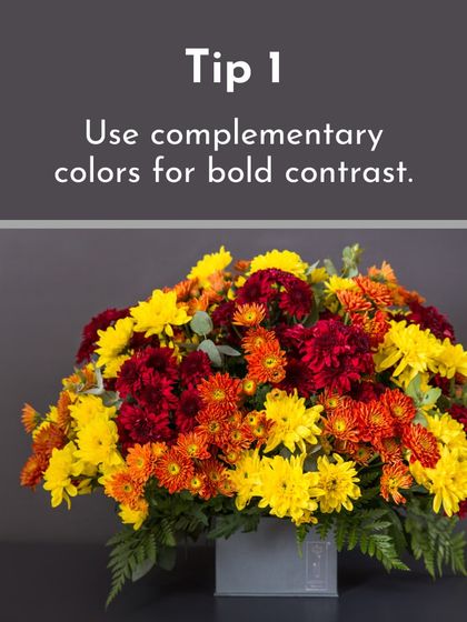 A perfect example of using complementary colors. The bold contrast between the red, orange, and yellow chrysanthemums makes this a very dynamic and eye-catching piece.