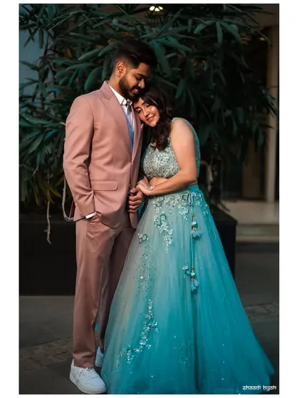 A relaxed and happy portrait. The bride leaning on the groom's shoulder shows their comfort and affection for each other.
