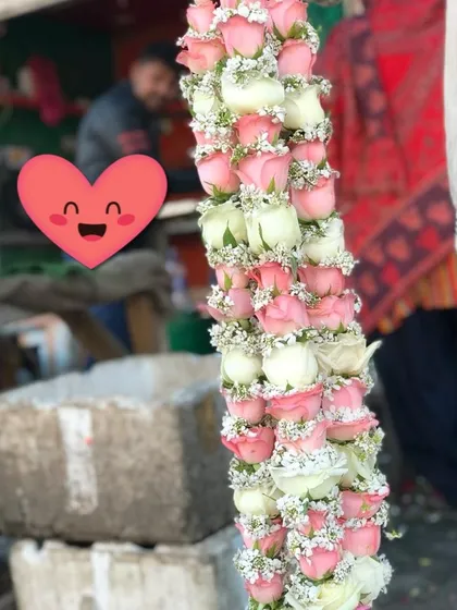 This wedding garland is crafted from delicate pink and white rose buds. It's a lighter, more modern style of jaimala that is very popular for engagements and weddings.