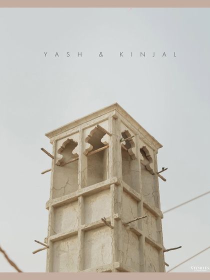 An architectural shot of a wind tower in Dubai, with the couple's names, setting the scene for their story.