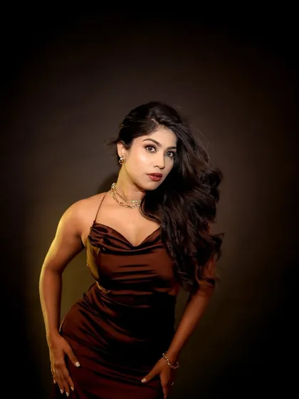 A studio portrait with dramatic lighting that creates a strong sense of mood. The model's pose and the play of light and shadow result in a captivating and artistic image.