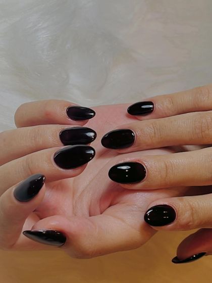 The full set of these dramatic and elegant black cherry nails. The uniform color and shape create a powerful and cohesive look.