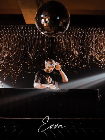 In my element under the disco ball at Evva, Delhi. A great DJ set is about reading the room and creating a vibe, and this shot captures that moment of focus before the beat drops. This is the atmosphere I create for high-energy club nights and private parties.