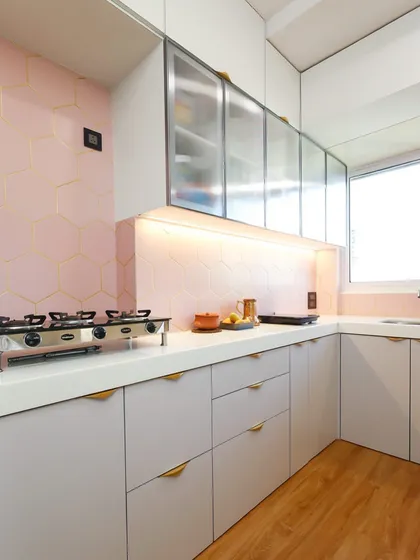The final result of our kitchen design, featuring soft pink hexagonal tiles with gold inlay, grey cabinets, and warm wooden flooring for a serene and modern look.