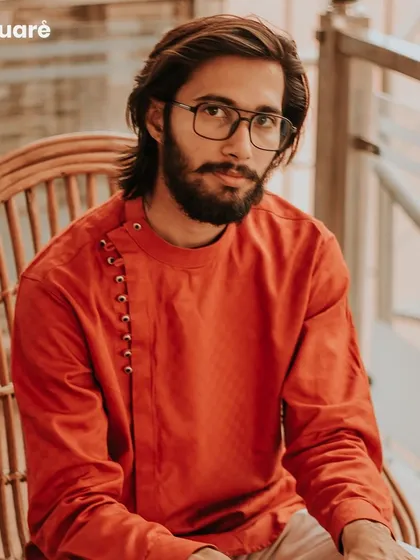 Experience the fusion of modern design and traditional comfort with our custom kurtas. This rust-orange kurta features a contemporary side-placket with loop buttons, offering a stylish and unique option for casual gatherings and festive occasions.