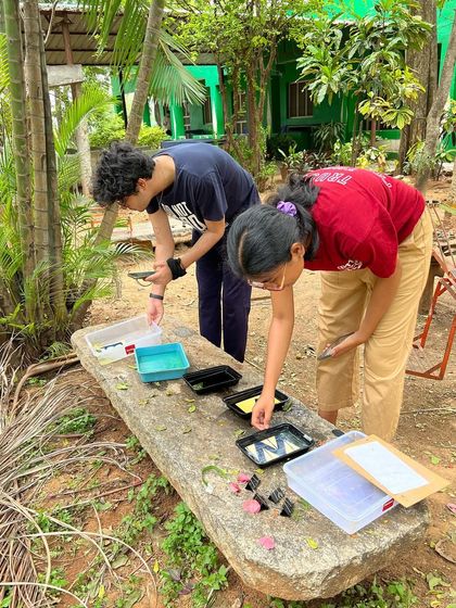 Young participants learning the cyanotype process during an off-site workshop in Kolar. Community engagement and making art accessible to all is a core part of our mission.