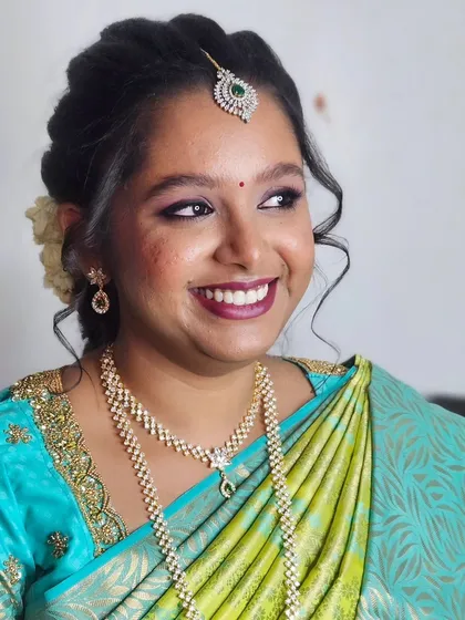 Jebha's engagement glam, showing her beautiful smile. The makeup is designed to enhance her natural features and make her feel confident.