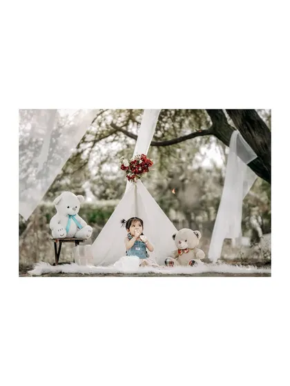 A quiet moment of play during an outdoor teepee session. The soft, natural light and dreamy setup make for beautiful and timeless photos.