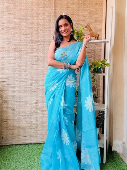 A beautiful sky blue pre-stitched cotton saree with a daisy print. This is a very fresh and summery saree, perfect for a casual day.