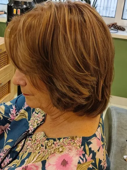 A detailed look at the layered cut and multi-dimensional colour. The highlights add texture and movement to her short, stylish bob.