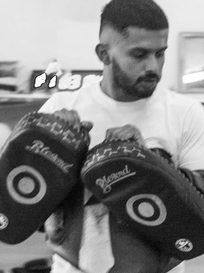 The coach's view. Holding pads is as much a skill as hitting them. We guide you through every punch, ensuring your technique is on point.