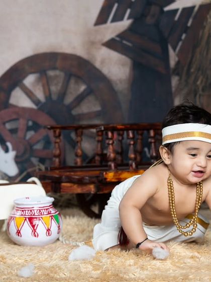 This little one is exploring the village setup, crawling around the hay and bullock cart.