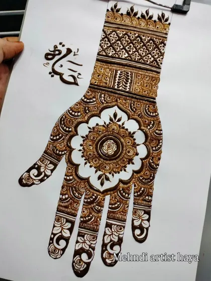 A beautiful mandala design on paper, featuring a central flower with negative space to make it pop. The wristband uses a geometric pattern, showing how to mix styles effectively.