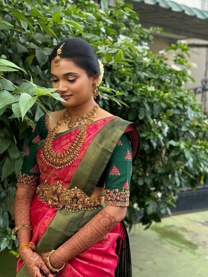 Ragavi in a moment of quiet contemplation. The soft makeup look is perfect for capturing these gentle, emotional moments during the wedding day.