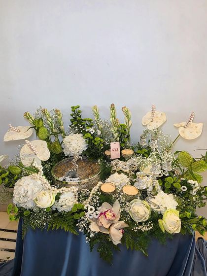 A wider shot of the elegant white and silver arrangement, perfect for weddings, anniversaries, or any formal celebration.