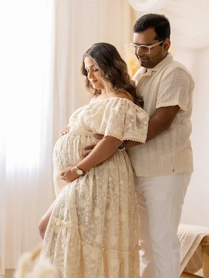 A gentle embrace from behind, this pose is perfect for showing the supportive and loving bond between the partners.