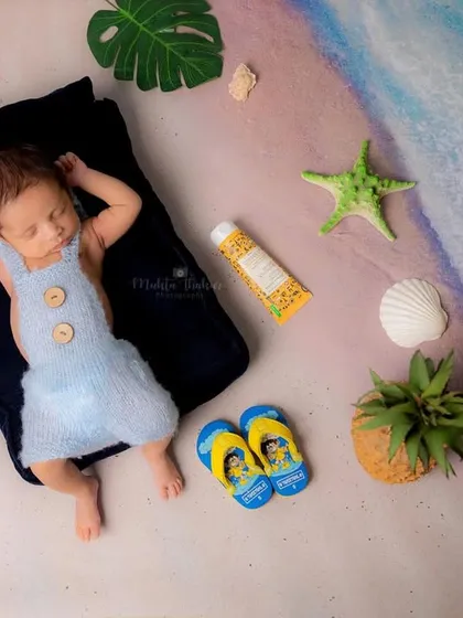 This little newborn is dreaming of sunny days and ocean waves. A beach-themed shoot is a wonderful way to capture those early days.
