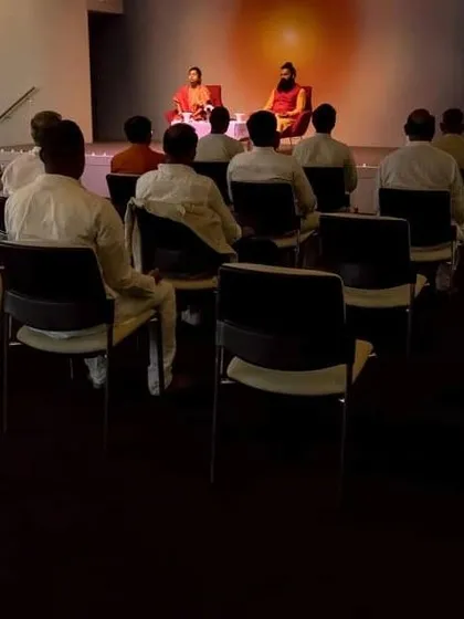 A view from the back of the audience during our meditation session in Sydney. This perspective shows the collective experience of participants meditating together under our guidance.