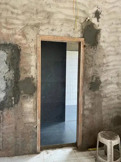 A doorway during construction, with freshly plastered walls meeting new tile work. This image captures the intersection of raw materials and finished surfaces, a pivotal moment in the journey of giving a space a new lease on life.