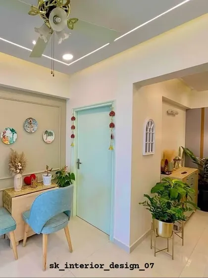 A charming entryway with pastel green doors and light wood furniture. We used decorative wall plates and plants to create a warm and welcoming first impression.