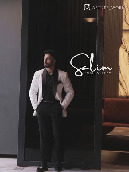 A client in a classic white tuxedo jacket with a black shawl lapel, paired with a black shirt. This monochrome look is effortlessly cool and sophisticated.