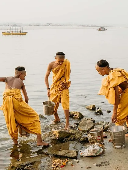 Young Batuks, or student monks, play and wash by the banks of the Ganga. This candid shot shows the simple joys and daily life that exist alongside deep spiritual learning in Varanasi.