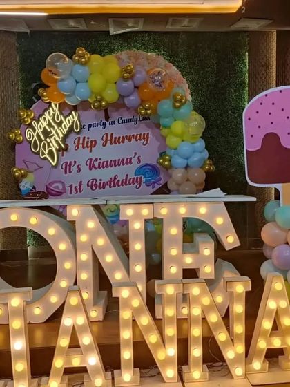 A sweet candyland-themed first birthday with large light-up marquee letters spelling "ONE" and the birthday girl's name, Kianna.