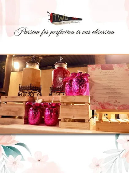 A beautiful mocktail bar setup for a Sangeet night, featuring pink glittery glasses and dispensers of our popular Paan Raas and Kokum Spritz.