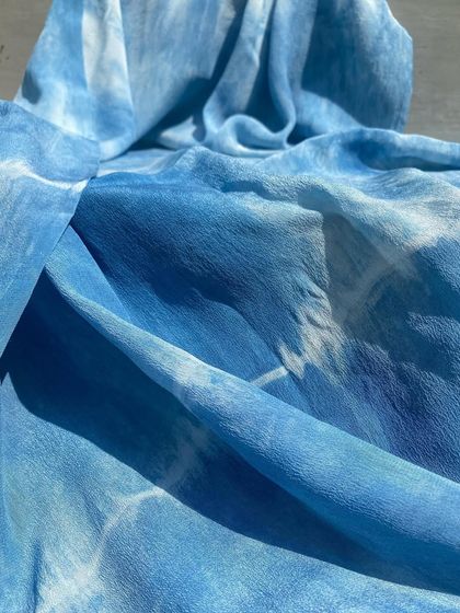 A stunning pure crepe dupatta dyed with natural indigo. The flowing fabric and the shades of blue are reminiscent of a river cascade or a bright blue sky.
