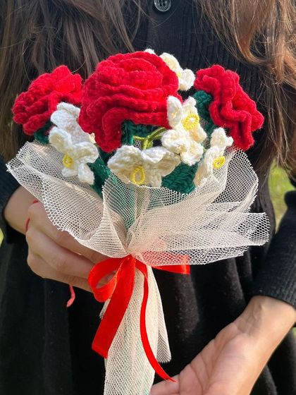 You had me at red roses. A beautiful, romantic bouquet of red roses and white forget-me-nots, wrapped with a delicate net and red ribbon.