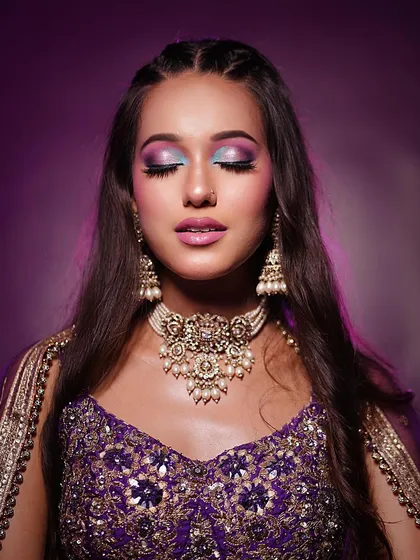 A close-up of this purple party look. The dual-toned blue and purple glittery eyeshadow is bold and creative, perfect for making a statement.