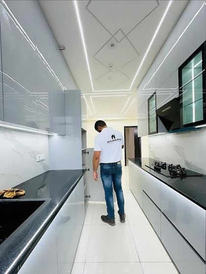 Checking the soft-close drawers and cabinets in this functional and stylish grey kitchen. Quality hardware is a key part of our promise.