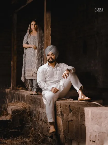 A more artistic, moody portrait from Aman and Simran's session. The focus on him in the foreground with her in the back creates a story and adds a cinematic quality to the image.