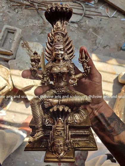 A 10-inch Panchaloha idol of Karumariamman, a beloved form of the mother goddess. The artisan's hand shows the scale of this small yet powerful custom piece.