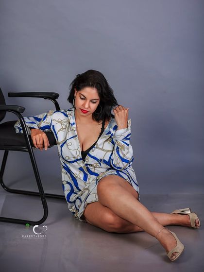 A moment of quiet introspection captured in the studio. The downward gaze and soft lighting create a pensive mood, telling a story of thought and feeling.