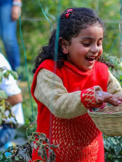 That smile says it all. The excitement of harvesting your own food is a magical experience for children, connecting them to the source of their nourishment in a fun and memorable way.