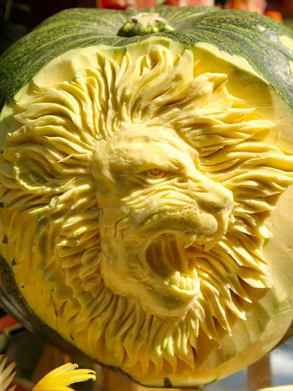 I also offer artistic fruit and vegetable carvings as part of my presentation. This incredibly detailed carving of a lion's face into a pumpkin is a true work of art that elevates any food display.