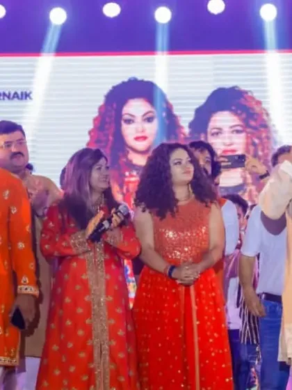 A group photo on stage with the event organizers. We are so thankful for their support and for a fantastic first day of Navratri.