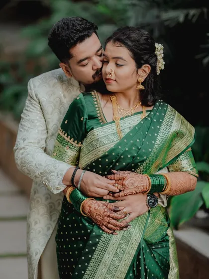 A tender and affectionate moment, with the groom kissing the bride's cheek. This is a classic romantic pose that beautifully captures their love and the joy of their engagement.