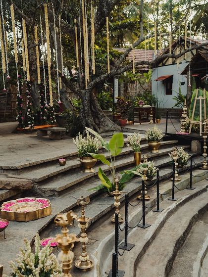 The stone steps of the Kalyani decorated with brass lamps and floral arrangements, creating a stunning visual.