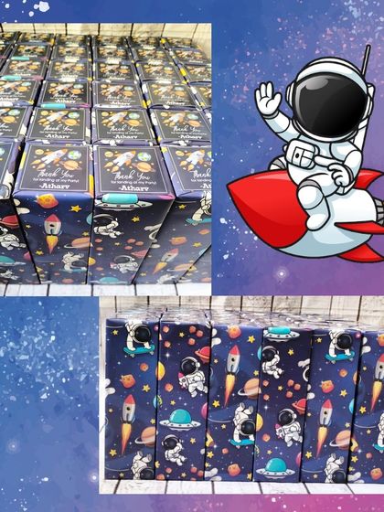 For a space-themed party, I wrapped these large stainless steel bottles in custom astronaut-themed paper with personalized thank you stickers.