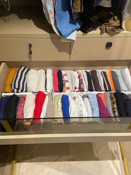 A drawer filled with perfectly folded t-shirts, organized by color. This system is a game-changer for anyone with a large collection of basics.