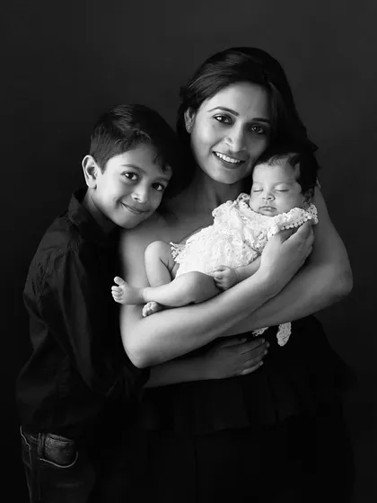 A mother, her son, and her newborn daughter. This portrait captures the love and warmth of a family, beautifully rendered in both color and timeless black and white.