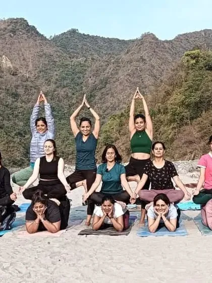 A fun partner yoga formation on the beach. We believe in making yoga accessible and enjoyable for everyone.