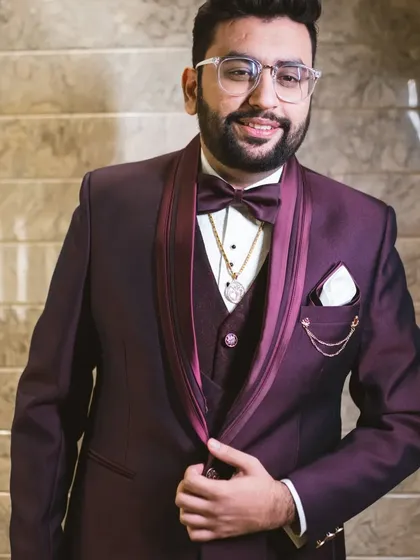 A close-up of the wine-colored five-piece suit. You can see the layering of the waistcoat and the sheen of the fabric, perfect for an evening reception or party.