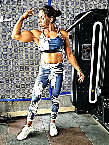 Striking a pose to show my arm and shoulder development. I teach my clients how to eat for performance and aesthetics, so you not only get stronger but also look the part.