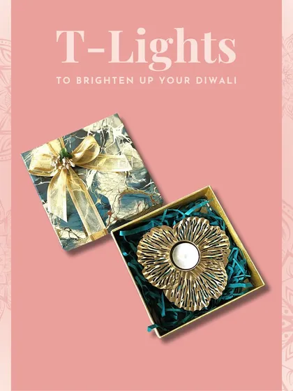 A golden floral T-light holder in a gift box. This is a classic and versatile piece that fits beautifully into any festive decor scheme.
